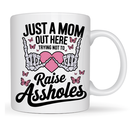 Just a mom trying not to raise assholes coffee mug