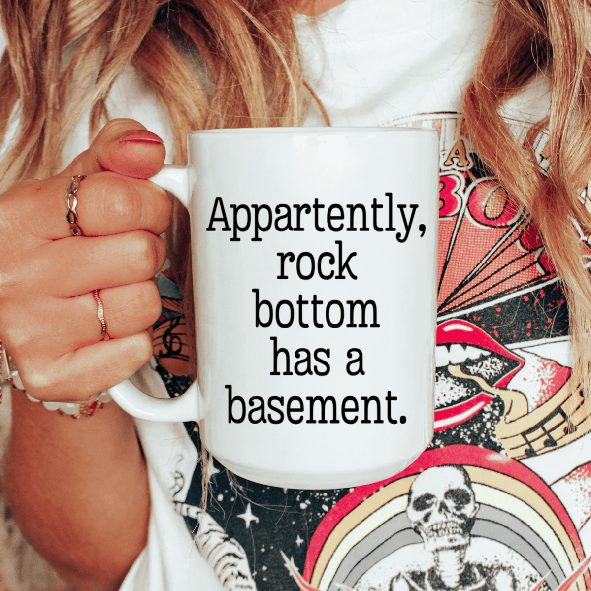 Sarcastic coffee mug featuring Apparently Rock Bottom Has a Basement saying in bold black typewriter-style text.