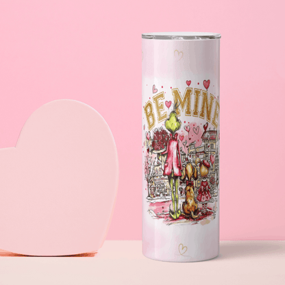 Tumbler with 'Be Mine' text and cartoon design on a pink background