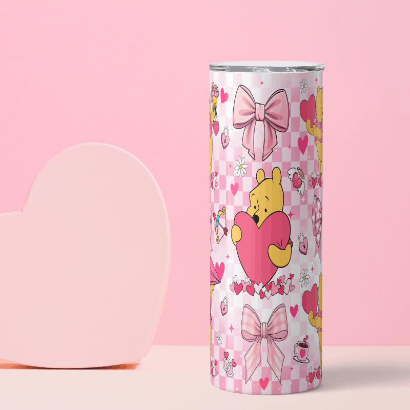 Tumbler with cartoon character holding a heart on a pink background