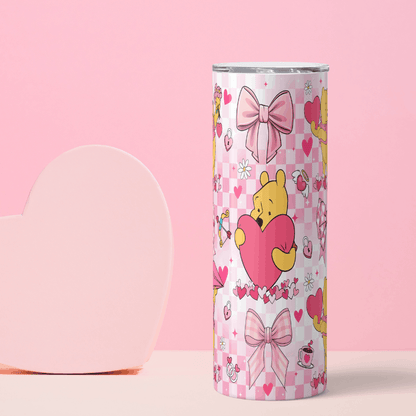 Tumbler with cartoon character holding a heart on a pink background
