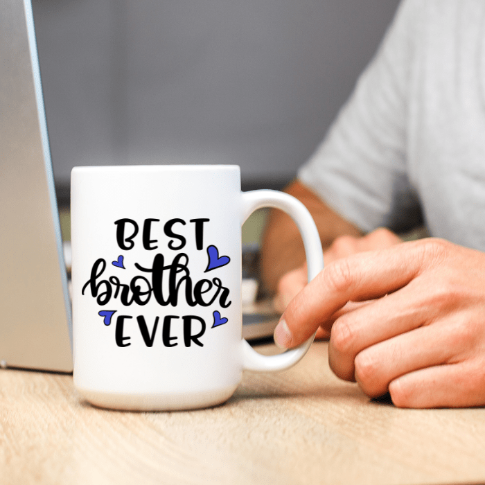 White mug with 'Best brother Ever' text on a desk with a blurred background