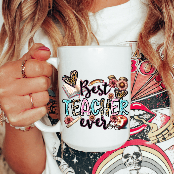 Person holding a mug with 'Best Teacher Ever' design