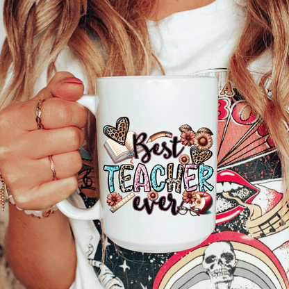 Person holding a mug with 'Best Teacher Ever' design