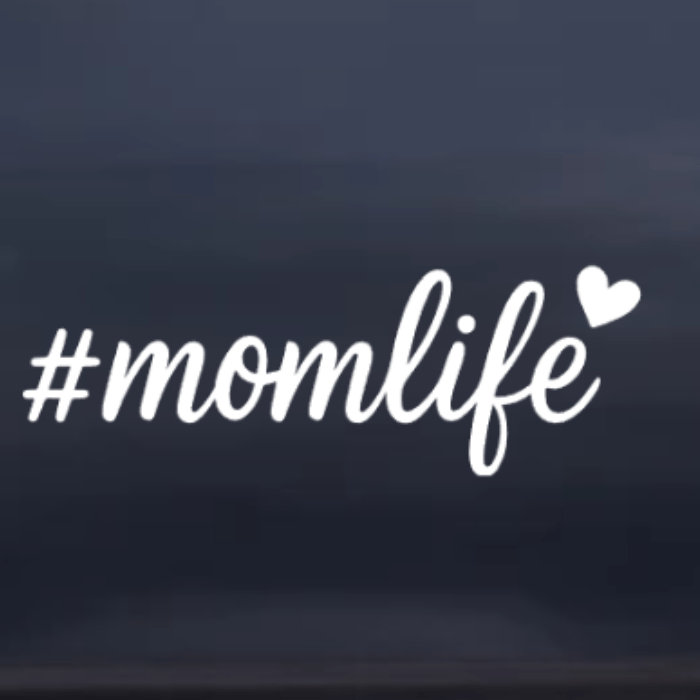 White '#momlife' text with a heart on a dark blue background