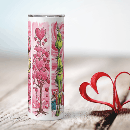 Tumbler with Grumpy grinch character design on a pink heart-themed background