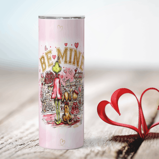 Tumbler with Valentine's Day design featuring 'Be Mine' text and cartoon characters on a light background.