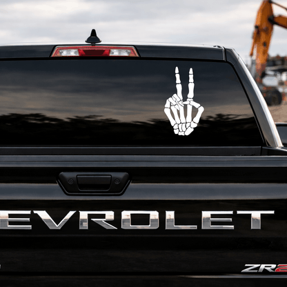 Chevrolet vehicle with a skeleton hand peace sign decal on the back window.
