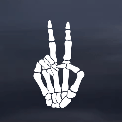 Skeleton hand making a peace sign on a dark background