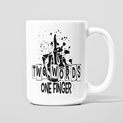 White 15 oz coffee mug with Two Words One Finger quote and black skeleton hand showing the middle finger.