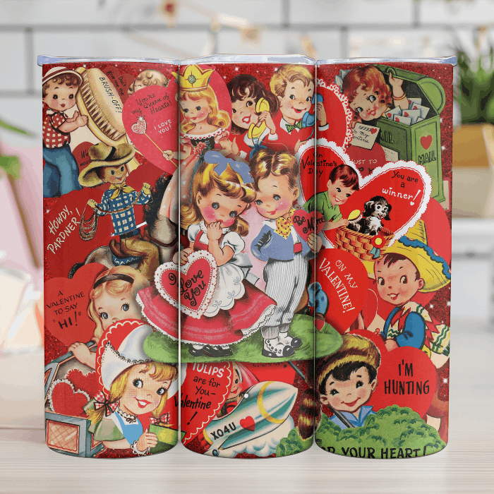 Three retro-style Valentine's Day-themed tins with vintage illustrations on a wooden surface.