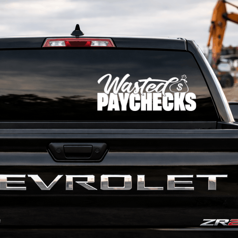 Back of a black Chevrolet truck with 'Wasted Paychecks' decal