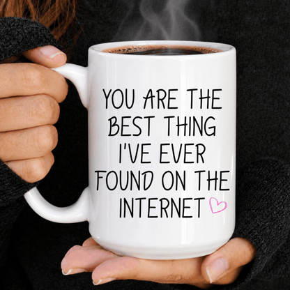 Funny romantic coffee mug with black handwritten lettering and small pink heart on white ceramic.