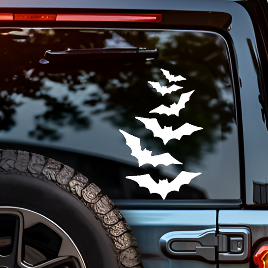 White bat-shaped decal on a vehicle's rear window